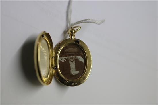 A 15ct gold and green enamel oval locket pendant, 30mm.